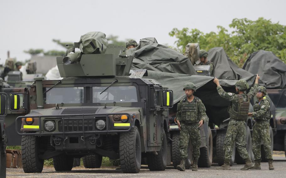 Soldiers cover M1167 HMMWV (High Mobility Multipurpose Wheeled Vehicle) anti-tank missile carriers during military drills in Taiwan.