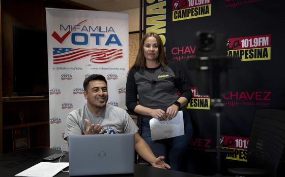 Staff members Michael Ruiz, left, and Marisol Moraga participate in a phone bank event at La Campesina, a Spanish-language radio network in Phoenix, Wednesday, March 20, 2024. A surge of misinformation is targeting Spanish-speaking voters with a high-stakes presidential election looming in the fall and candidates vying for support from the rapidly growing number of Latino voters. In one of the most important swing states, Arizona, La Campesina is countering that with a dedicated effort to provide Latino voters the facts about voting and how elections are run. (AP Photo/Serkan Gurbuz)