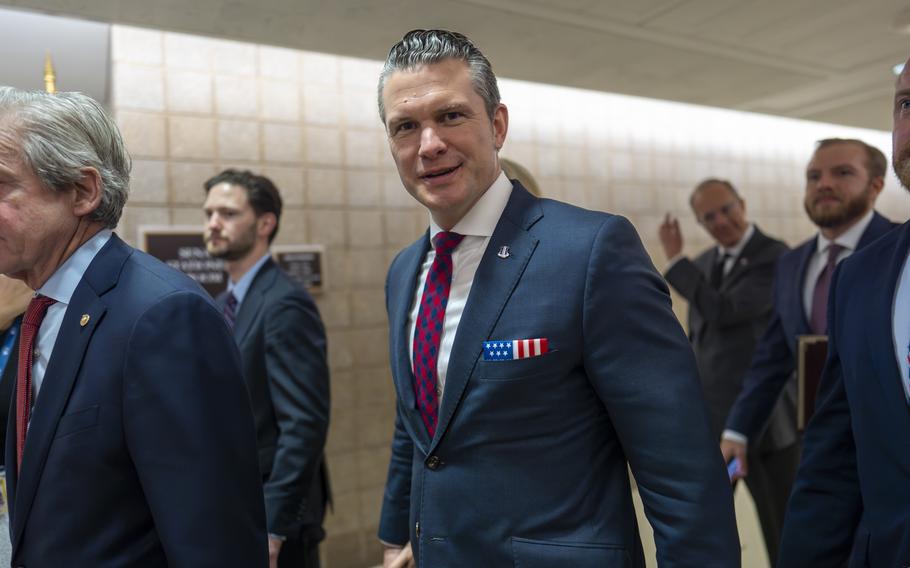 Pete Hegseth walking with government officials.