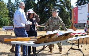 U.S. Army Col. Kent Park, Joint Base Lewis-McChord Garrison Commander, and the Honorable Marilyn Strickland, U.S. representative from Washington's 10th congressional district, don hard hats during a ceremony for the construction of new barracks for Soldiers, August 7, 2024, Joint Base Lewis-McChord, Washington. The goal of the new barracks are to both enhance the quality of life of Soldiers across the installation and evaluate the effectiveness of sustainable building materials on environmental sustainability, infrastructure resilience, cost-effectiveness and construction timeliness. (U.S. Army photo by Spc. Derick Fennell, I Corps Public Affairs)