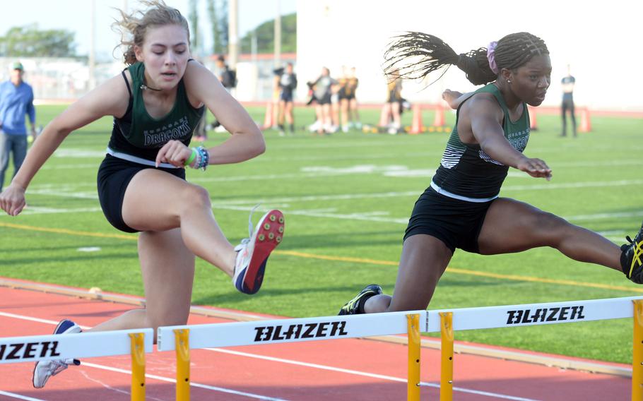 Kubasaki's Isabella Suber and Kenya Jones crest over the last set of hurdles in the 100-meter hurdles, during Saturday's second day of a two-day Okinawa track and field meet. Suber won in 18.07 seconds.
