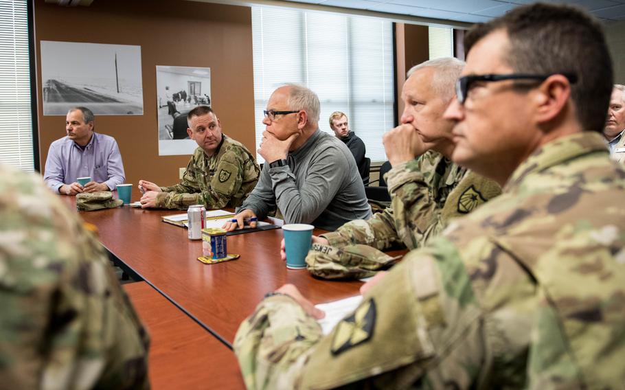 Minnesota Gov. Tim Walz, center, listens to local authorities in 2019 talk about the damage caused by a winter storm. Minnesota National Guard leaders and Walz listen to how the 224th Transportation Company assisted after the storm. 