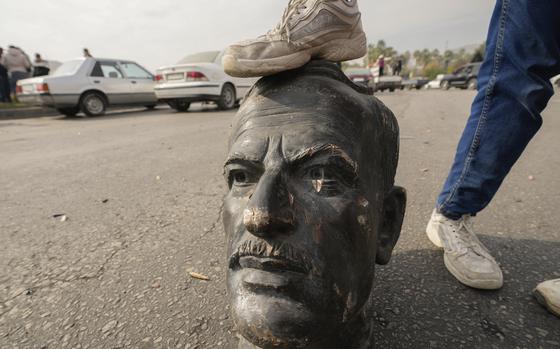 The head of a statue getting stepped on.