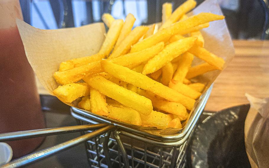 French fries from Mars Burger Co. are served in a wire basket.