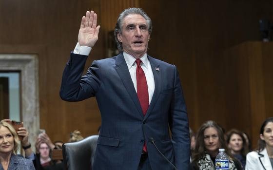 Former Gov. Doug Burgum, President-elect Donald Trump's choice to lead the the Interior Department as Secretary of the Interior, is sworn-in as he testifies before the Senate Energy and Natural Resources Committee on Capitol Hill in Washington, Thursday, Jan. 16, 2025. (AP Photo/Jose Luis Magana)