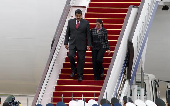 Venezuela President Nicolas Maduro, left, and First Lady Cilia Flores arrive in Beijing in September 2015.