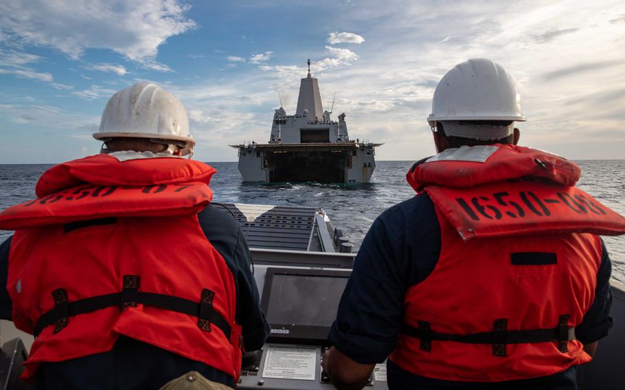 Chief Quartermaster Jesse Glover, left, and Boatswain’s Mate 1st Class Diony Angeles assigned to Beach Master Unit 2 maneuver a landing craft, utility into the well deck of the San Antonio-class amphibious transport dock ship USS Arlington on Aug. 18, 2021. Arlington is deployed to U.S. Naval Forces Southern Command/U.S. 4th Fleet to support humanitarian assistance and disaster relief efforts in Haiti.