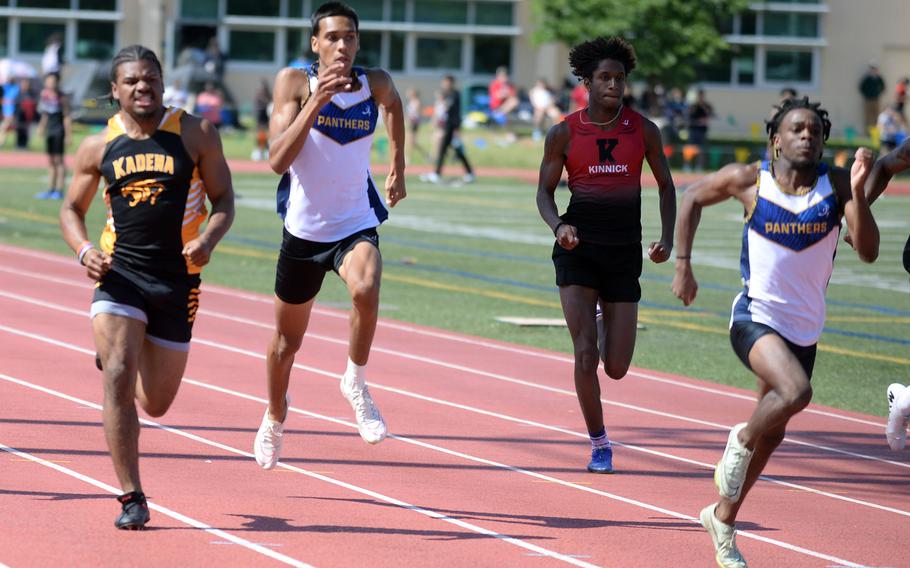 Kadena’s D’Kylan Woods, Guam High’s Jayden Jackson and Aaron Johnson and Nile C. Kinnick’s Jaelin White dash for the finish in the 200 during Day 2 of the Far East track and field meet. Johnson and Woods placed 1-2.