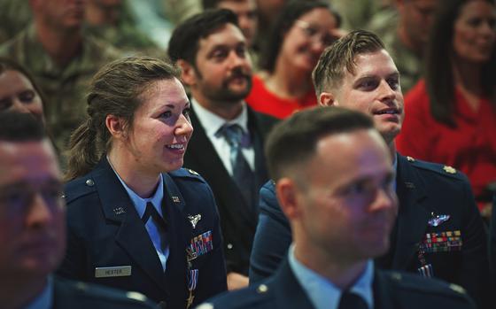 Capt. Lacie Hester, left, and Maj. Benjamin Coffey, right, watch the closing of an award ceremony at RAF Lakenheath in England on Nov. 12, 2024. Each received a Silver Star. 