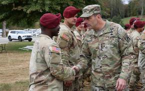 Commanding General of the XVIII Airborne Corps, Lt. Gen. Christopher Donahue, shakes hands with a Soldier assigned to Bravo Company, 1st Battalion, 325th Airborne Infantry Regiment, 82nd Airborne Division, at LSA Castle in Marion, North Carolina, Oct. 15, 2024. Donahue and his team visited Soldiers at LSA Castle who are supporting the Hurricane Helene relief efforts. (U.S. Army photo by Sgt. Alison Strout)