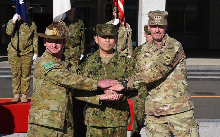 Australian army Maj. Gen. Ash Collingburn, Japan Ground Self-Defense Force Lt. Gen. Toshikazu Yamane and U.S. Army Lt. Gen. Joel Vowell pose.