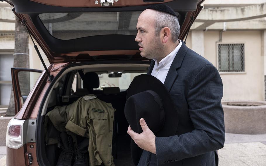 Mordechai Porat leaves his home in Bnei Brak, Israel, on Thursday to serve with the Israel Defense Forces. He enlisted after Hamas attacked Israeli communities on Oct. 7. 