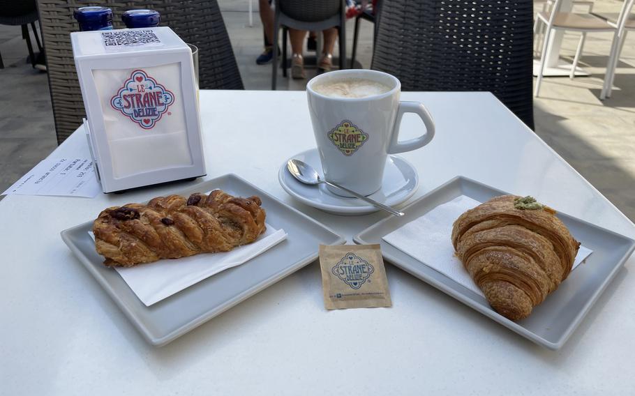 Two brioches and a latte macchiato ready to be enjoyed at Le Strane Delizie cafe in Spilimbergo, Italy, on Aug. 17, 2024.