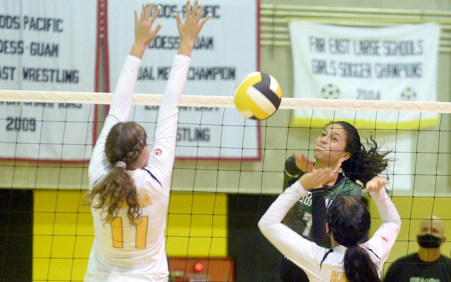 Kubasaki's Sophia Grubbs spikes over the double block of Kadena's Presley Pearce and Joan Buysman during Thursday's Okinawa volleyball match. The Dragons beat the Panthers in straight sets for the 11th time this season.