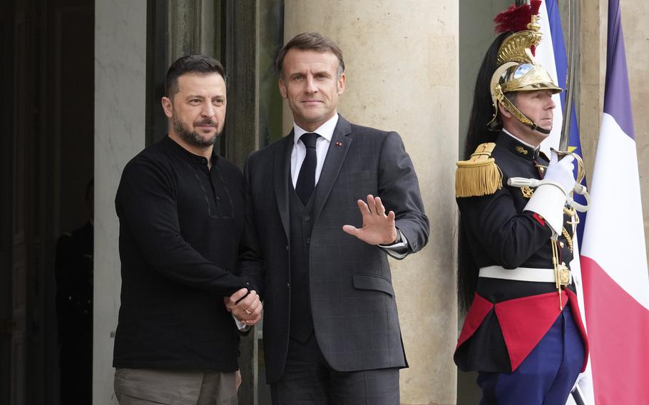 French President Emmanuel Macron, right, welcomes his Ukrainian counterpart Volodymyr Zelenskyy before a meeting at the Elysee Palace, in Paris, Thursday, Oct. 10, 2024. (AP Photo/Michel Euler)