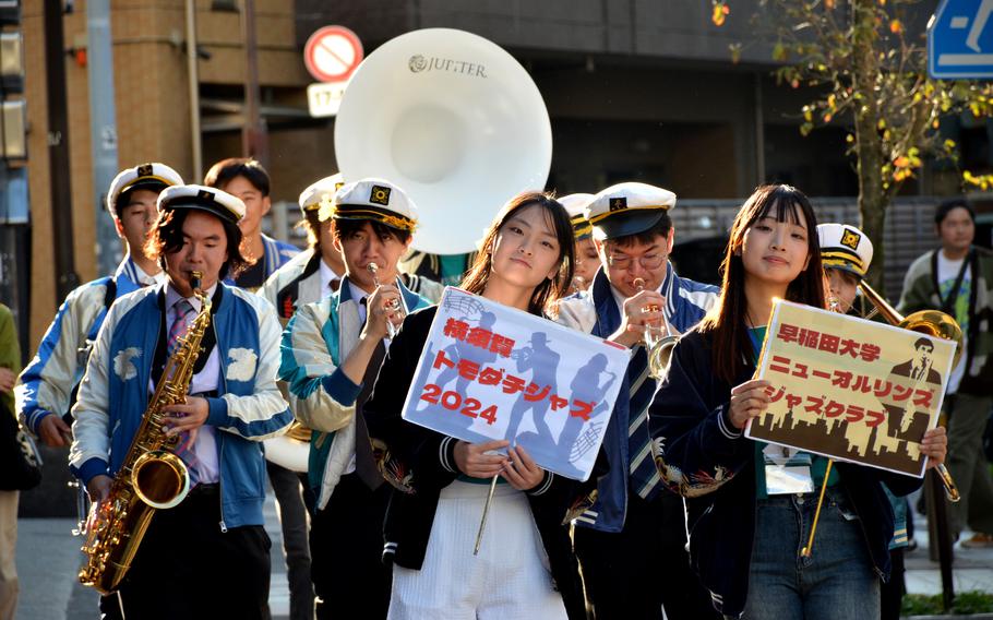 Members of Waseda University's jazz club march down the Honch during the annual jazz and rock festival in Yokosuka, Japan, Nov. 4, 2024.