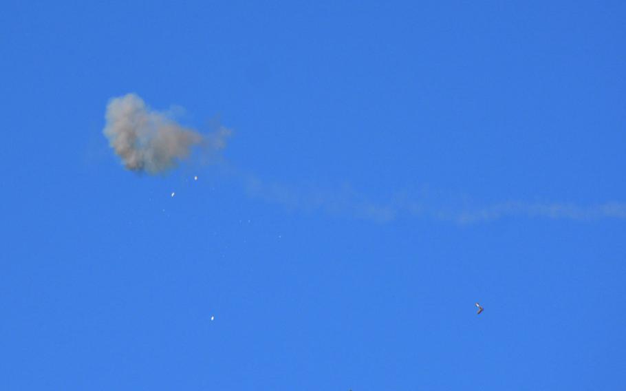 Shattered bits of drone fall to the ground after a Stinger missile fired from the Marine Air Defense Integrated System obliterated it during live-fire training at Pohakuloa Training Area, Hawaii, Jan. 25, 2025.