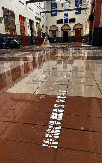 The missing middle section of the passenger terminal roof at Aviano Air Base is reflected in the water on the building’s floor after a storm swept through the area on July 12, 2024.