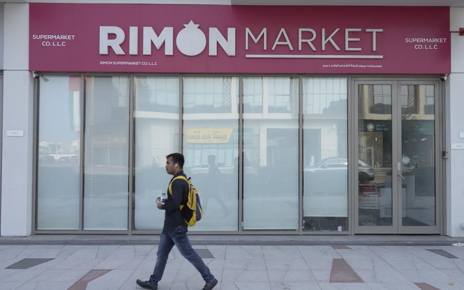 A man walks past the Rimon Market in Dubai.