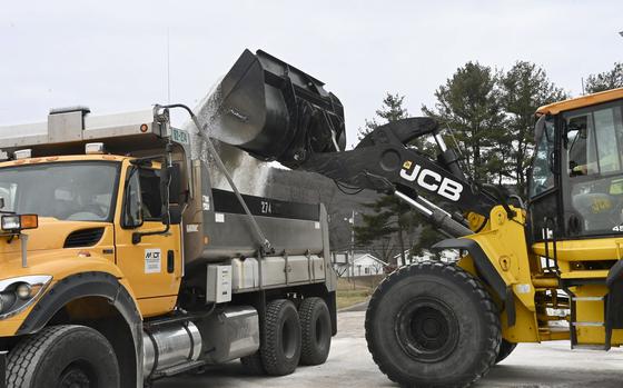 Maryland Department of Transportation employees use a backhoe to load a truck with salt at the State Highway Administration District 6 Office in LaVale, Md., Wednesday, Feb. 5, 2025. (Steve Bittner/Cumberland Times-News via AP)