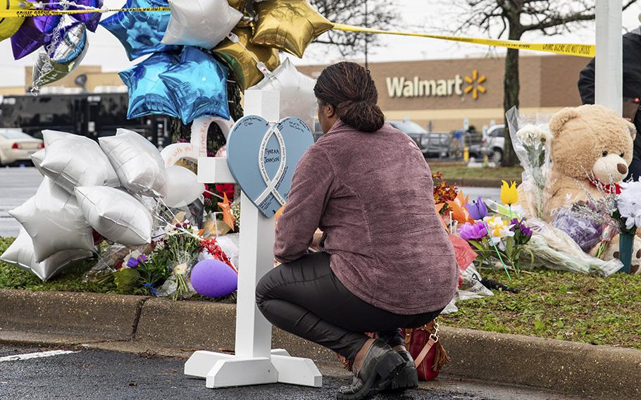 Trisha Mathews on Nov. 25, 2022, signs a personal message for one of the victims of the Walmart mass killing in Chesapeake, Va.