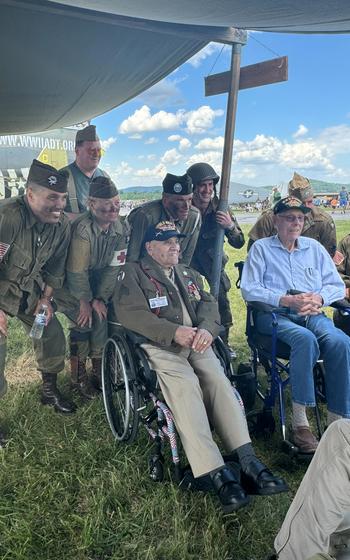 World War II veterans Andy Valero, front left, and Leo Dormon, front right, with participants at a Virginia air show they attended earlier this summer. 