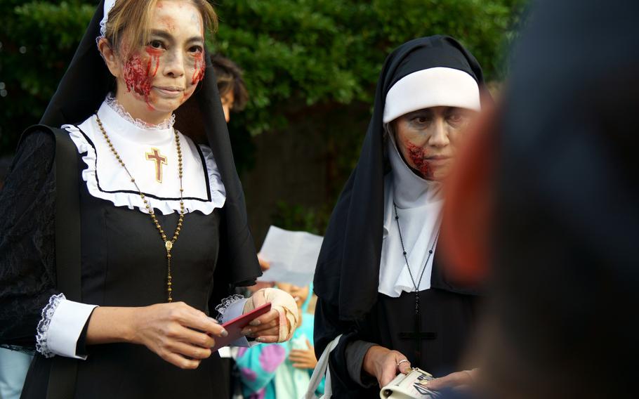 A pair of spooky nuns wait to enter Yokosuka Naval Base, Japan, on Halloween, Oct. 31, 2024.