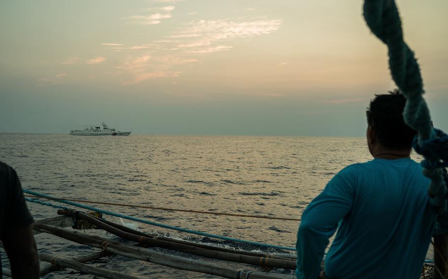 Jory Aguian, the son of a shipbuilder and captain of the Paty, watches as a Chinese coast guard ship maneuvers near his boat. 