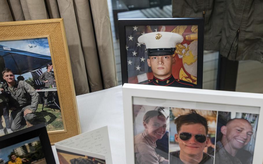 Photographs of Marine Cpl. Spencer R. Collart and fellow service members sit on a table in frames.