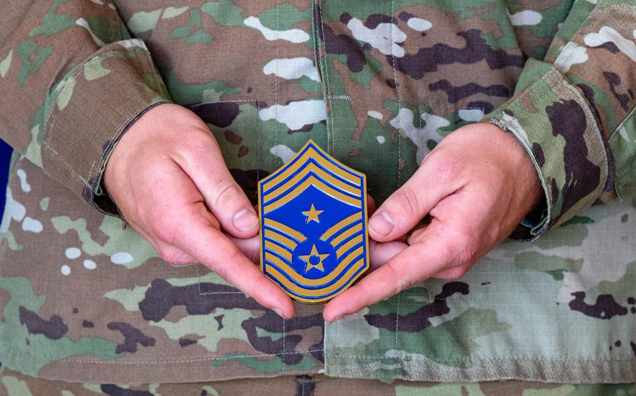 An airman displays the 99th Air Base Wing command chief master sergeant coin during a ceremony at Nellis Air Force Base, Nev., Aug. 26, 2024. Seven airmen were presented with coins to acknowledge their efforts in saving lives during a flash flood at Zion National Park. 