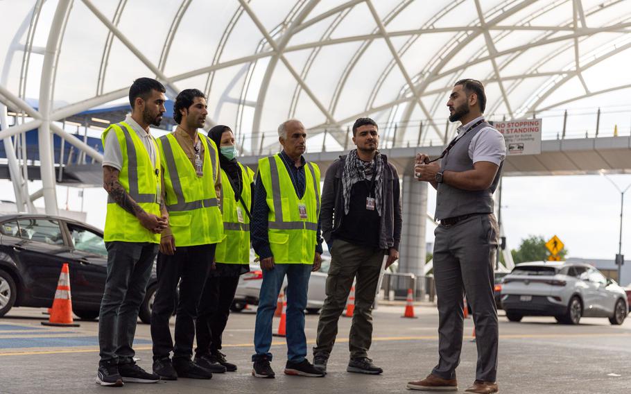 Mirwais Jalali, right, a recruiter for aviation contractor Unifi, prepares to give new employees a tour of the Hartsfield-Jackson airport in Atlanta on Friday, April 19, 2024.