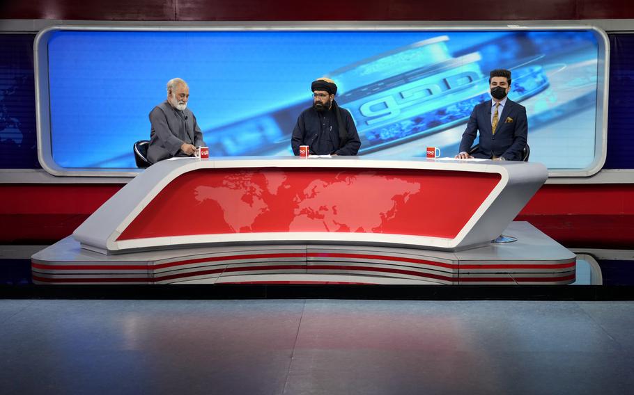 TV anchor Nesar Nabil wears a face mask to protest the Taliban’s new order that female presenters cover their faces, as he reads the news on TOLOnews, in Kabul, Afghanistan, Sunday, May 22, 2022.