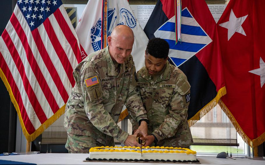 U.S. Army Lt. Col. Dan Urquhart and Pfc. Nasir Neighbors use the ceremonial sword to cut the cake during a cake cutting ceremony to celebrate the Army’s 249th birthday on Fort Stewart, Ga., June 13, 2024. 