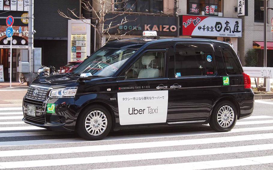 An Uber taxi operates in Tokyo in this undated photo. 