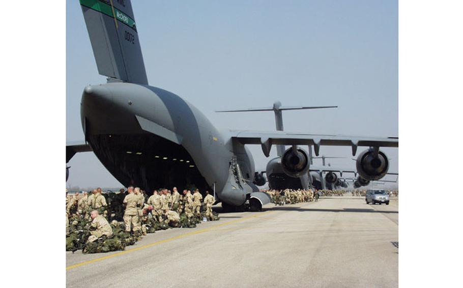 More than a dozen C-17 transport planes parked nose-to-tail on the taxiway at Aviano Air Base, Italy, made more than a few heads turn. The sight got even more impressive when the camouflaged 173rd Airborne Brigade marched out to await passage to Iraq.