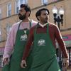 Saagar Shaikh, left, and Asif Ali wearing their aprons in a scene from “Deli Boys.” 