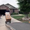 A mover rolls a service members' household goods onto a truck at Fort Knox, Ky., April 12, 2022.