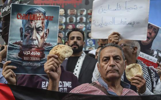 Egyptian activists hold bread as they participate in a pro-Palestinian ...