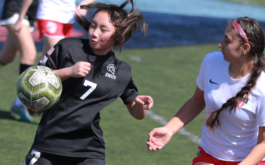 Zama’s Shyene Choi plays the ball in front of Nile C. Kinnick’s Rachael Vite during Saturday’s DODEA-Japan girls soccer match. The Red Devils won 6-0.