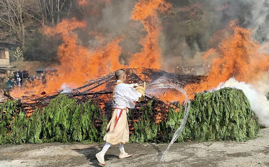 Monks build a bonfire.