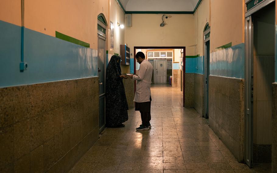 A woman speaks with a doctor while waiting for counseling at the hospital in Herat.