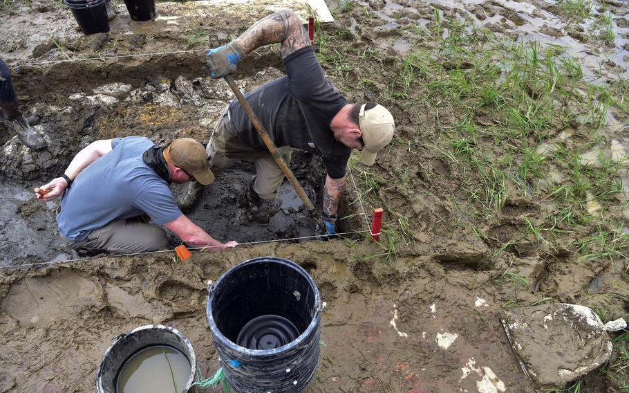 Marine Corps Staff Sgt. Joshua Alexander, left, and Navy Petty Officer 1st Class Joshua Weber, of the Defense POW/MIA Accounting Agency, take part in an excavation in Quang Binh Province, Vietnam, Feb. 26, 2023.