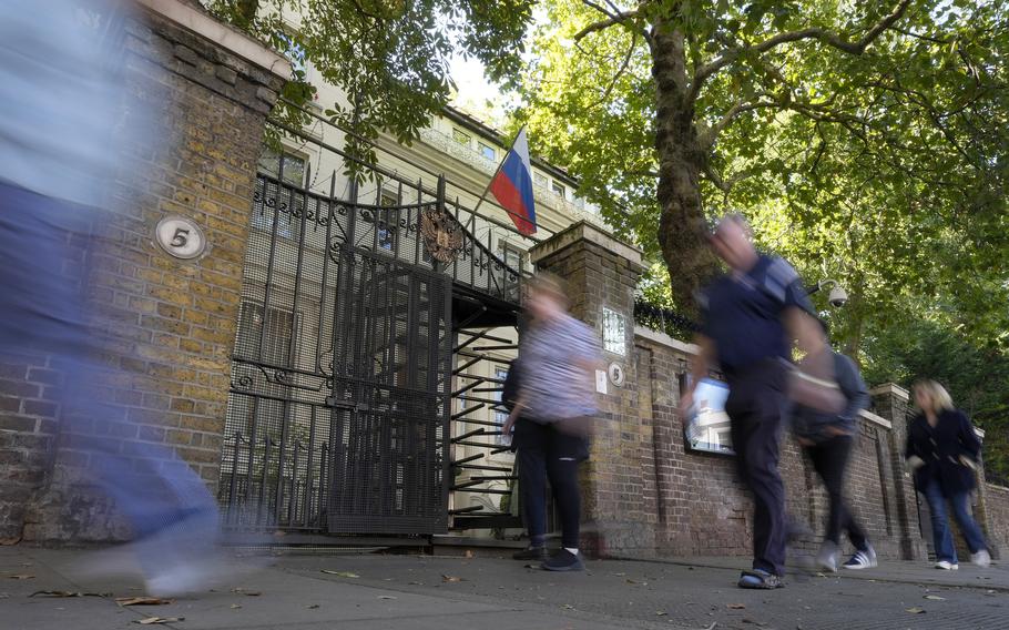 People walk past the Russian Embassy in London.