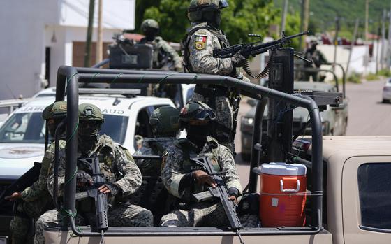 National Guards and Army forces patrol the streets during an operation in a neighborhood of Culiacan, Sinaloa state, Mexico, Thursday, Sept. 19, 2024. (AP Photo/Eduardo Verdugo)