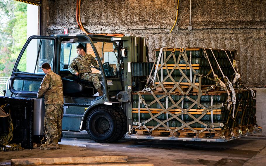 U.S. Air Force personnel in Dover, Del., move pallets of explosive charges for 155mm artillery ammunition bound for Ukraine in October 2022.