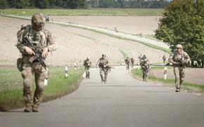 Soldiers with the 173rd Airborne Brigade march through a town after parachuting into into a village field outside of the Joint Multinational Readiness Center Hohenfels Training Area, Germany, for Exercise Saber Junction on Sept. 4, 2024.