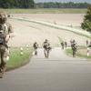 Soldiers with the 173rd Airborne Brigade march through a town after parachuting into into a village field outside of the Joint Multinational Readiness Center Hohenfels Training Area, Germany, for Exercise Saber Junction on Sept. 4, 2024.