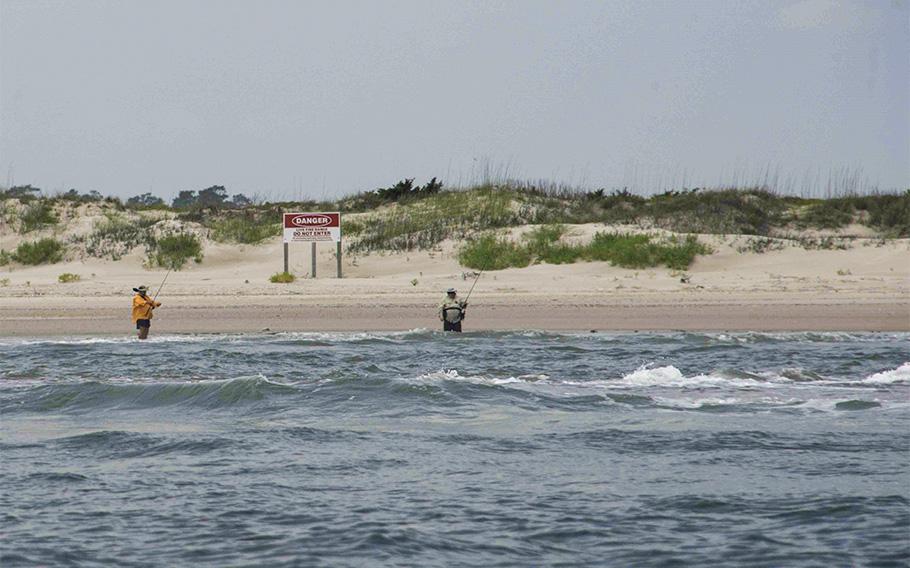 Two men illegally fish on Browns Island in the Atlantic‐Intracoastal Waterway on May 25, 2018. 