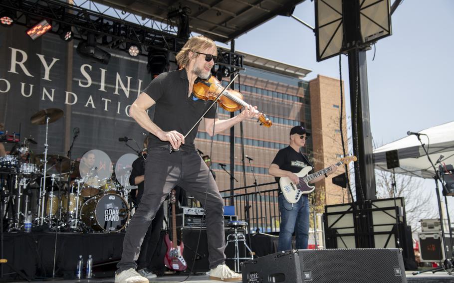 A man plays the violin on stage