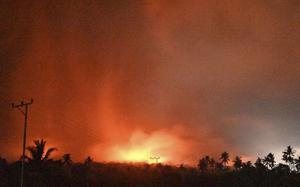 In this photo made available by Indonesia's Center for Volcanology and Geological Disaster Mitigation Agency (PVMBG) of the Ministry of Energy and Mineral Resources, the sky glows from the eruption of Mount Lewotobi Laki-Laki early Monday, Nov. 4, 2024, in East Flores, Indonesia. (PVMBG via AP)